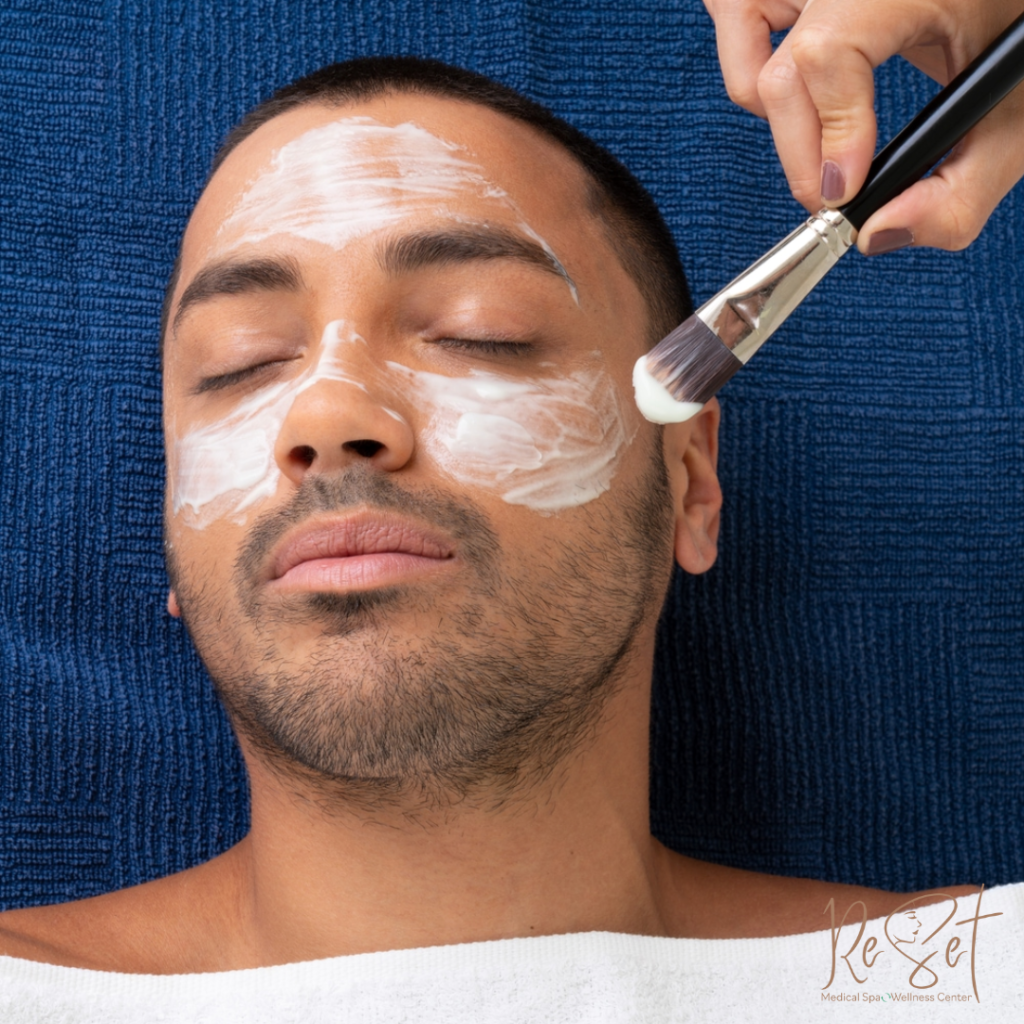 Image of dark skinned make receiving a relaxing and results driven facial with medical grade men's skincare.